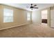 Large bedroom with neutral walls, carpet, two windows, and bathroom access at 9445 Sweetwood Ave, Las Vegas, NV 89149