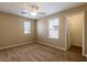 Comfortable bedroom with neutral paint, carpet, ceiling fan and natural light from two windows at 9445 Sweetwood Ave, Las Vegas, NV 89149