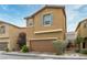 Two-story home with a two-car garage, manicured front landscaping, and decorative shutters at 9445 Sweetwood Ave, Las Vegas, NV 89149