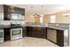 Kitchen with stainless steel appliances, dark wood cabinets, and granite countertops at 9445 Sweetwood Ave, Las Vegas, NV 89149