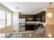 Kitchen with dark cabinets, stainless steel appliances, granite counters, and a stainless sink at 9445 Sweetwood Ave, Las Vegas, NV 89149
