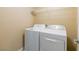 Laundry room with a white washer and dryer set and wire shelving for storage at 9445 Sweetwood Ave, Las Vegas, NV 89149