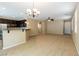 Bright living room with carpet, adjacent kitchen with breakfast bar, ceiling fan, and ample space at 9445 Sweetwood Ave, Las Vegas, NV 89149