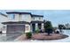 Two-story home featuring a stone-accented facade, a two-car garage, and a well-maintained front yard landscape at 9670 Gentle Spirit Dr, Las Vegas, NV 89148