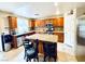 Kitchen features an island with seating, stainless steel appliances, and ample cabinet space at 9670 Gentle Spirit Dr, Las Vegas, NV 89148