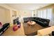 Spacious living room with a fireplace, large windows, and comfortable seating arrangement at 9670 Gentle Spirit Dr, Las Vegas, NV 89148