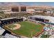 Aerial view of Las Vegas Ballpark surrounded by city buildings with mountain views, a vibrant entertainment hub at 10341 Birch Bluff Ln, Las Vegas, NV 89145