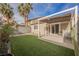 Outdoor living space with patio, artificial grass, and mature landscaping for relaxation and entertainment at 10341 Birch Bluff Ln, Las Vegas, NV 89145