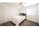 Comfortable bedroom featuring a ceiling fan, a queen bed, and a large window at 10341 Birch Bluff Ln, Las Vegas, NV 89145