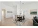 Bright and airy dining room with modern lighting, seating for six, and tile flooring, great for entertaining at 10341 Birch Bluff Ln, Las Vegas, NV 89145