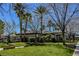 Beautifully landscaped community grounds with lush green grass and palm trees providing shade at 10341 Birch Bluff Ln, Las Vegas, NV 89145