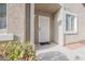 Inviting front door entrance with a stylish screen door and manicured bushes at 10341 Birch Bluff Ln, Las Vegas, NV 89145