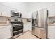 Kitchen with stainless steel appliances, white cabinets, and bright lighting for a modern and clean aesthetic at 10341 Birch Bluff Ln, Las Vegas, NV 89145