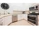 Updated kitchen with white cabinetry, stainless steel appliances, modern fixtures and decorative accents at 10341 Birch Bluff Ln, Las Vegas, NV 89145