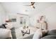 Comfortable living room featuring a plush gray sofa, stylish decor, and sliding glass doors to the backyard at 10341 Birch Bluff Ln, Las Vegas, NV 89145