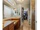 Bathroom featuring double sinks, granite countertops, tiled shower, and walk-in closet at 1050 Cracker Barrel Cir, Mesquite, NV 89034