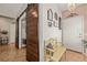 Inviting entryway featuring a charming yellow bench, decorative wall art, and a sliding barn door, creating a warm and stylish welcome at 1050 Cracker Barrel Cir, Mesquite, NV 89034