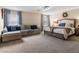 Spacious main bedroom with a lounge area and a king-size bed at 10909 Prudhoe Bay St, Las Vegas, NV 89179