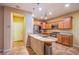 Well-lit kitchen featuring a granite island, stainless steel appliances, and tile flooring at 11242 Almador Vista Ct, Las Vegas, NV 89135