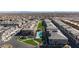 Aerial view of a townhome community featuring manicured green spaces and a shared pool at 11439 Peak Landing Ave, Las Vegas, NV 89138