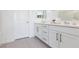 Bathroom features a double vanity, white cabinets, and tiled floors at 11439 Peak Landing Ave, Las Vegas, NV 89138