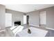 Large bedroom features light wood flooring, and a seating area with a television at 11439 Peak Landing Ave, Las Vegas, NV 89138