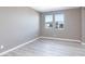 Neutral bedroom with hardwood floors, two windows, and a calming ambiance at 11439 Peak Landing Ave, Las Vegas, NV 89138