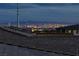 Panoramic city view of Las Vegas skyline from rooftop patio featuring bright lights at night at 11439 Peak Landing Ave, Las Vegas, NV 89138