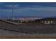 Panoramic city view of Las Vegas skyline from rooftop patio featuring bright lights at night at 11439 Peak Landing Ave, Las Vegas, NV 89138
