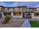 Contemporary townhome showcasing stone accents, covered entryway, and low-maintenance landscaping at 11439 Peak Landing Ave, Las Vegas, NV 89138