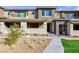 Charming two-story townhouse with neutral exteriors, manicured landscaping and walkway at 11439 Peak Landing Ave, Las Vegas, NV 89138