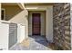 Stylish front entryway with a stone accent wall and dark wooden door at 11439 Peak Landing Ave, Las Vegas, NV 89138