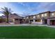 Charming exterior with well-manicured lawn, community pool, and mountain views at 11439 Peak Landing Ave, Las Vegas, NV 89138