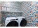 Laundry room features patterned wallpaper and modern Whirlpool washer and dryer at 11439 Peak Landing Ave, Las Vegas, NV 89138