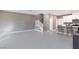 Open-concept living space with tile flooring, stairs, and a kitchen with bar seating at 11439 Peak Landing Ave, Las Vegas, NV 89138