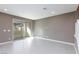 Spacious living room with tile flooring and sliding glass doors leading to a patio at 11439 Peak Landing Ave, Las Vegas, NV 89138