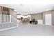 Bright, open-concept living space with tile flooring and modern white kitchen at 11439 Peak Landing Ave, Las Vegas, NV 89138
