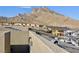 View of the rooftop deck, neighborhood, and nearby mountains at 11439 Peak Landing Ave, Las Vegas, NV 89138