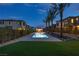 Community pool surrounded by artificial turf and palm trees at 11439 Peak Landing Ave, Las Vegas, NV 89138