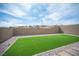 Spacious backyard featuring artificial grass and gravel landscaping and block wall at 11701 Hatchling Ave, Las Vegas, NV 89138