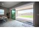View of backyard from inside, with a large sliding glass door leading to the patio at 11701 Hatchling Ave, Las Vegas, NV 89138