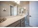 Bright bathroom featuring white countertop, modern gray cabinets, and decorative accents at 11701 Hatchling Ave, Las Vegas, NV 89138