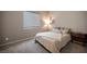 Cozy bedroom features a plush bed, neutral decor, and soft, patterned carpet at 11701 Hatchling Ave, Las Vegas, NV 89138