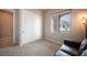 Spare bedroom showcases neutral walls and carpet, a view to the outdoors, and closet at 11701 Hatchling Ave, Las Vegas, NV 89138
