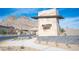 Falcon Crest community entrance with stone signage and manicured landscaping against a mountain backdrop at 11701 Hatchling Ave, Las Vegas, NV 89138