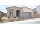 Charming single-story home featuring a welcoming front porch, desert landscaping, and a two-car garage at 11701 Hatchling Ave, Las Vegas, NV 89138