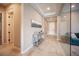 Inviting hallway with stylish console table, neutral walls, and tile flooring at 11701 Hatchling Ave, Las Vegas, NV 89138