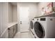 Well-equipped laundry room featuring modern washer and dryer, ample counter space and a bright, clean aesthetic at 11701 Hatchling Ave, Las Vegas, NV 89138