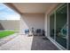Covered patio featuring outdoor seating area and a view of the backyard with artificial grass at 11701 Hatchling Ave, Las Vegas, NV 89138