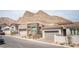 A neighborhood street showcasing modern homes with desert landscaping, complemented by a view of mountains at 11701 Hatchling Ave, Las Vegas, NV 89138